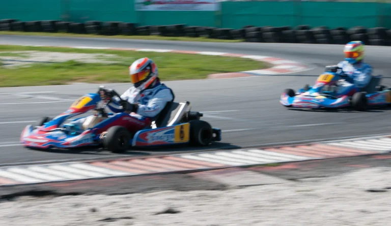Unrecognised man driving Go-kart with speed in the on a karting track
